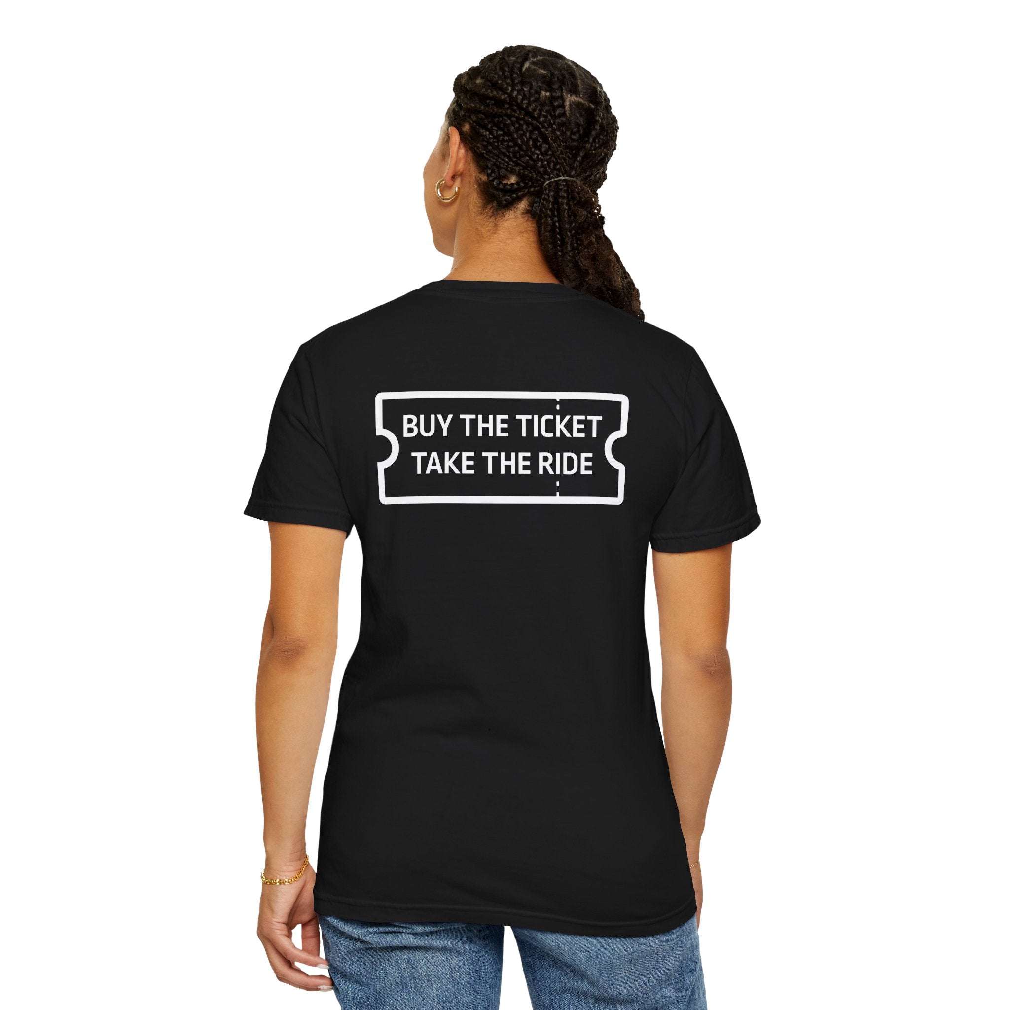 A person is wearing the Printify "Buy The Ticket Tee," a premium black shirt made from 100% US cotton. It features a ticket graphic and the phrase "BUY THE TICKET TAKE THE RIDE" on the back, combining style with comfort.