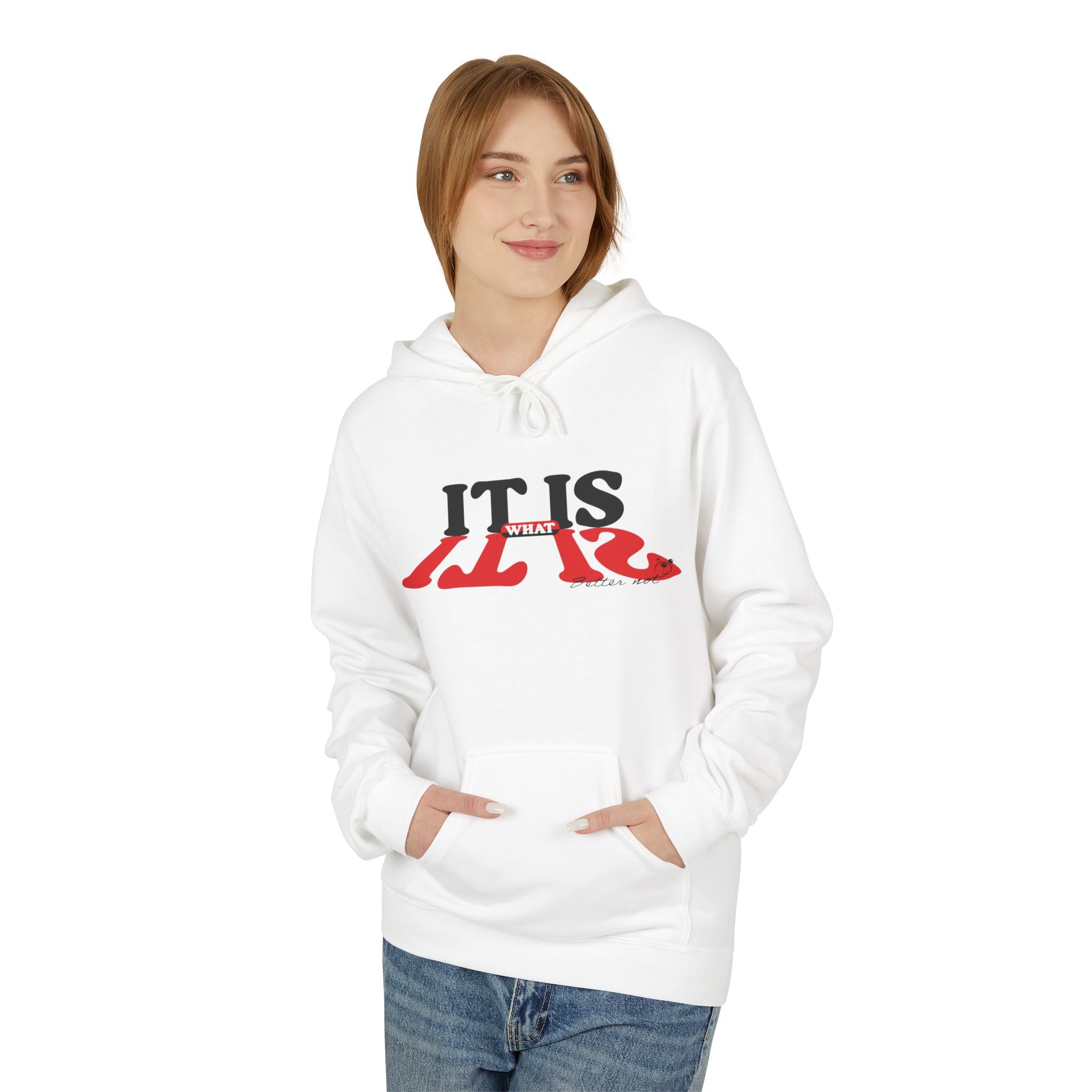 A person wears Printify's eco-friendly "It Is What It Is" hoodie in white, featuring a graphic text design, and has their hands in the front pockets. They pair it with blue jeans.