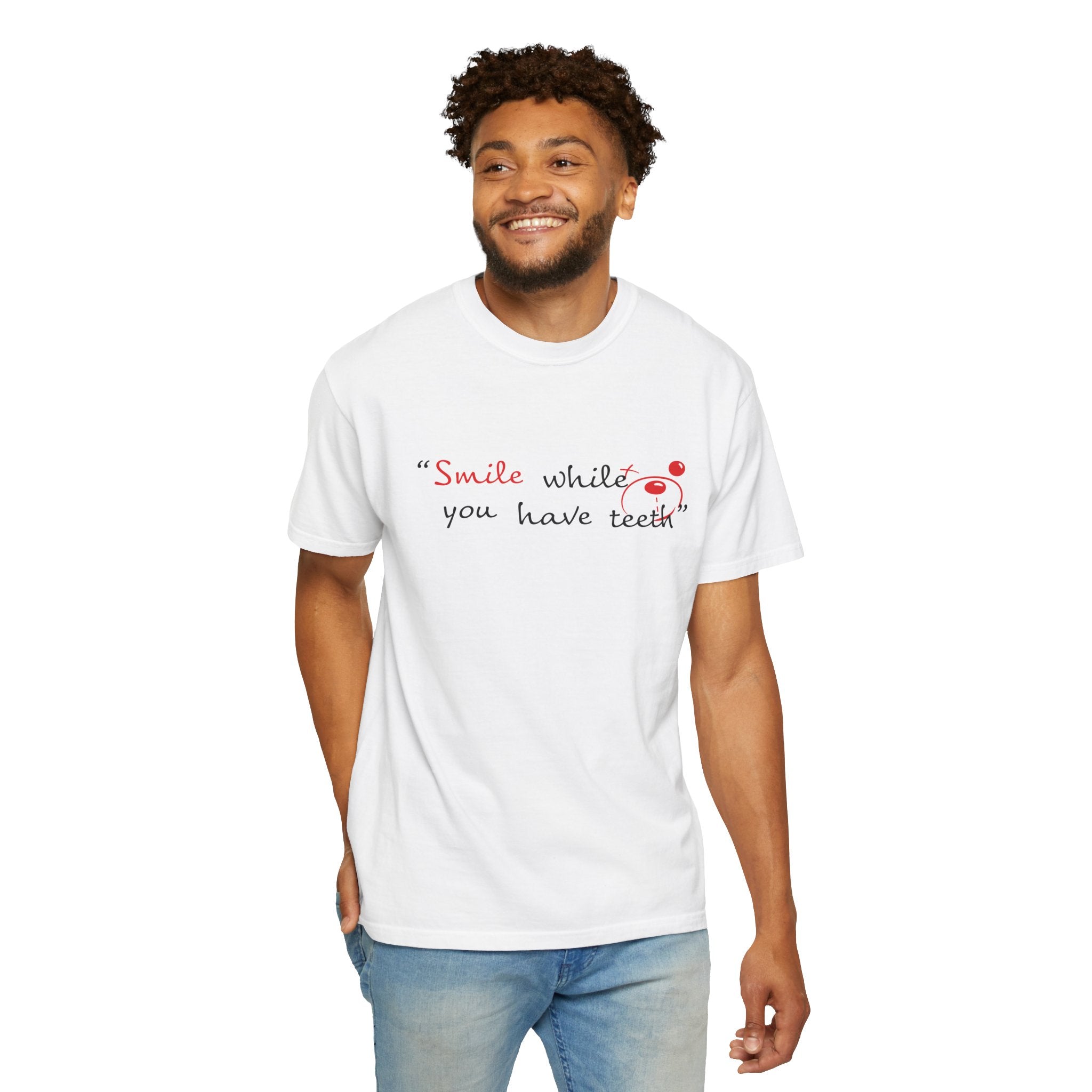 A man stands and smiles in a Printify Just Smile Tee, crafted from 100% US cotton Comfort Colors 1717, featuring “Smile while you have teeth” printed on the front.