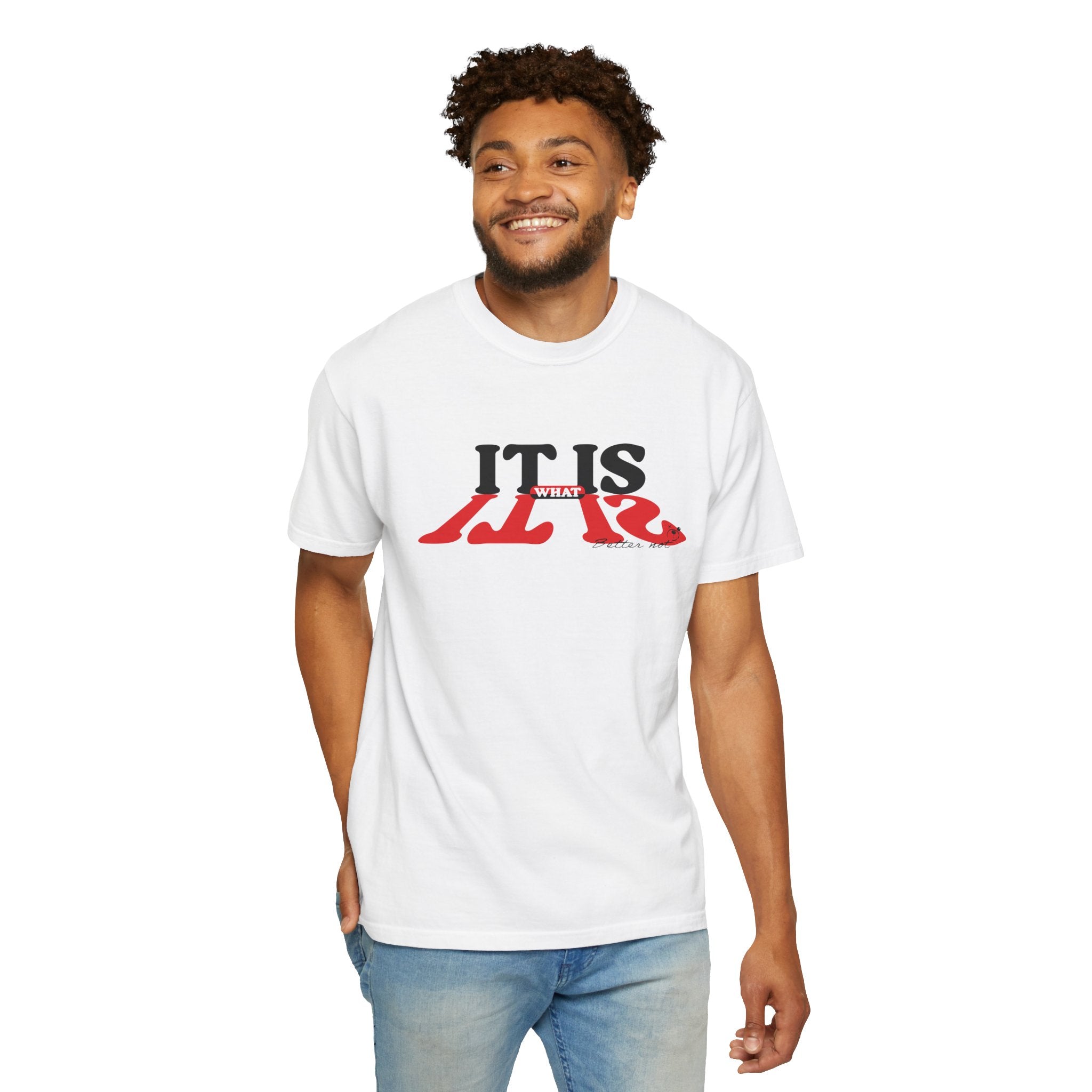 A smiling man wears the Printify "It Is What It Is Tee," made of 100% US cotton, featuring the phrase in bold red and black, paired with light blue jeans.