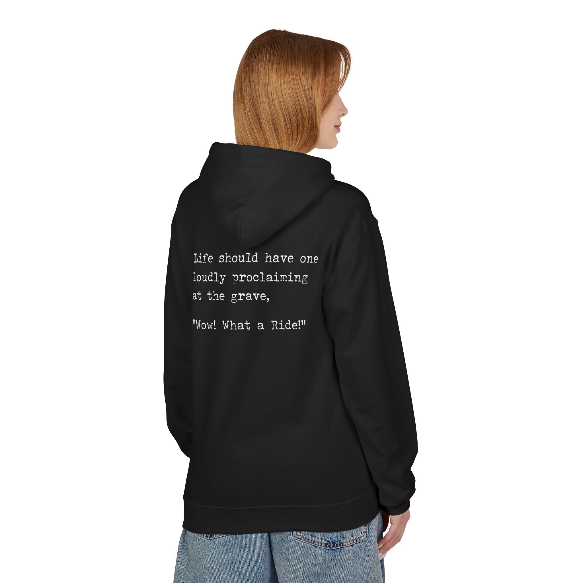 A person in a classic fit, black "What a Ride" hoodie by Printify with the text: "Life should have one loudly proclaiming at the grave, 'Wow! What a Ride!'" They are turned to the side with short brown hair and blue jeans. The hoodie is sustainably crafted using eco-friendly methods.