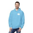 A man in a light blue Graffiti Bear Hoodie by Printify, crafted sustainably and eco-consciously, smiles with one hand in his pocket.