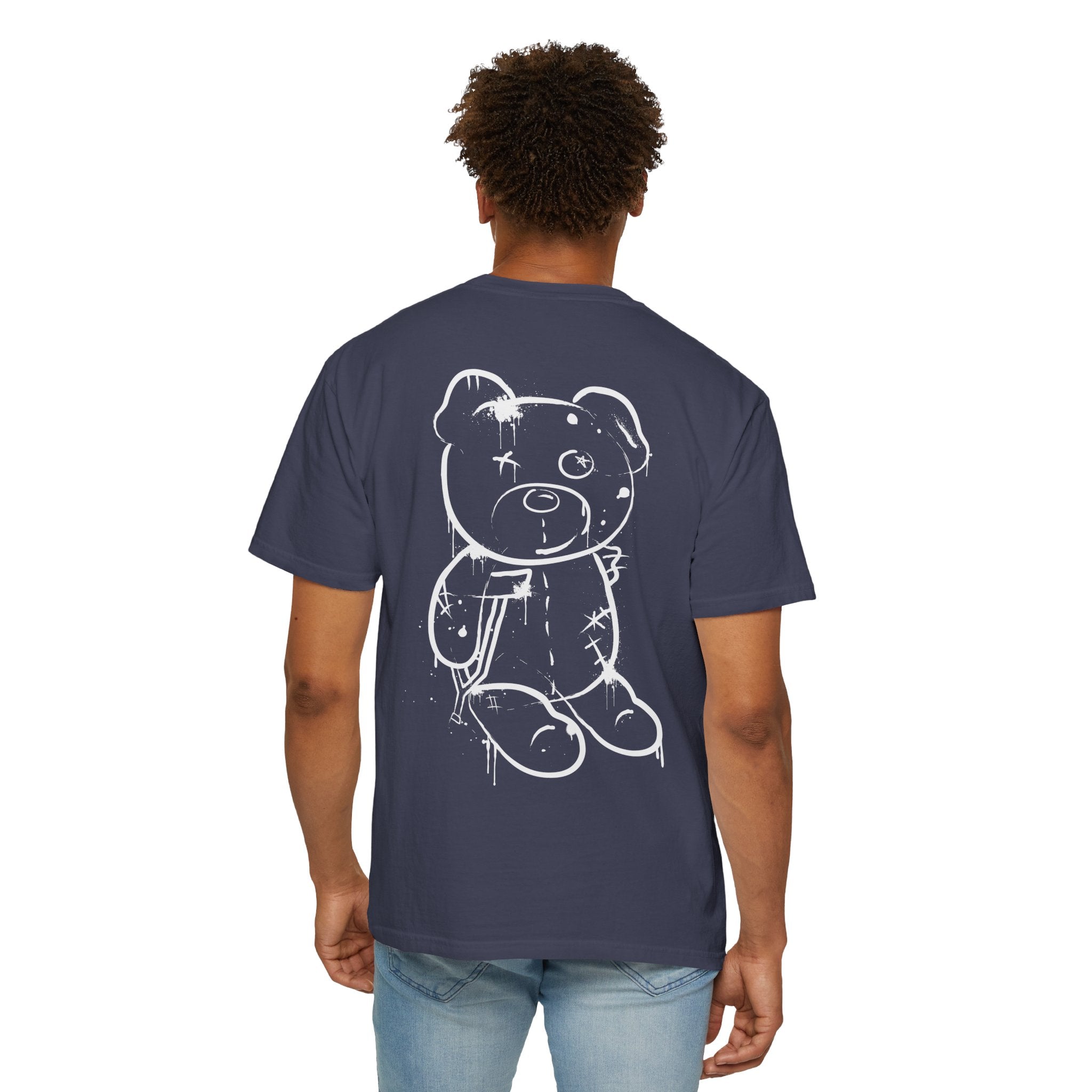 A person is wearing a navy blue Graffiti Bear Tee from Printify, made of 100% US cotton, featuring a white sketch-style bear design on the back.