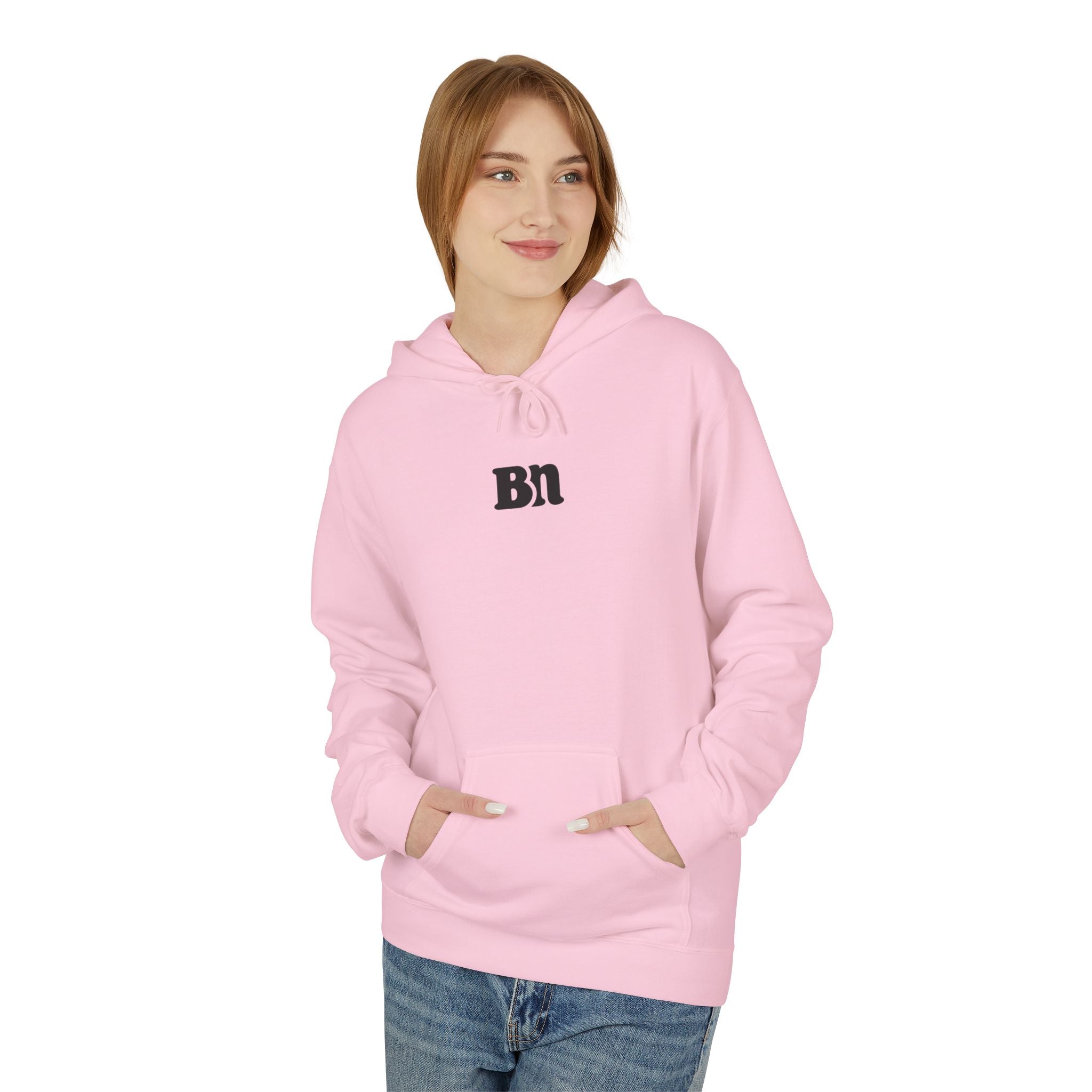 A person in a pink "Bad decisions" hoodie by Printify stands hands-in-pocket against a white background. This eco-friendly product represents sustainable fashion, blending style with ethics.