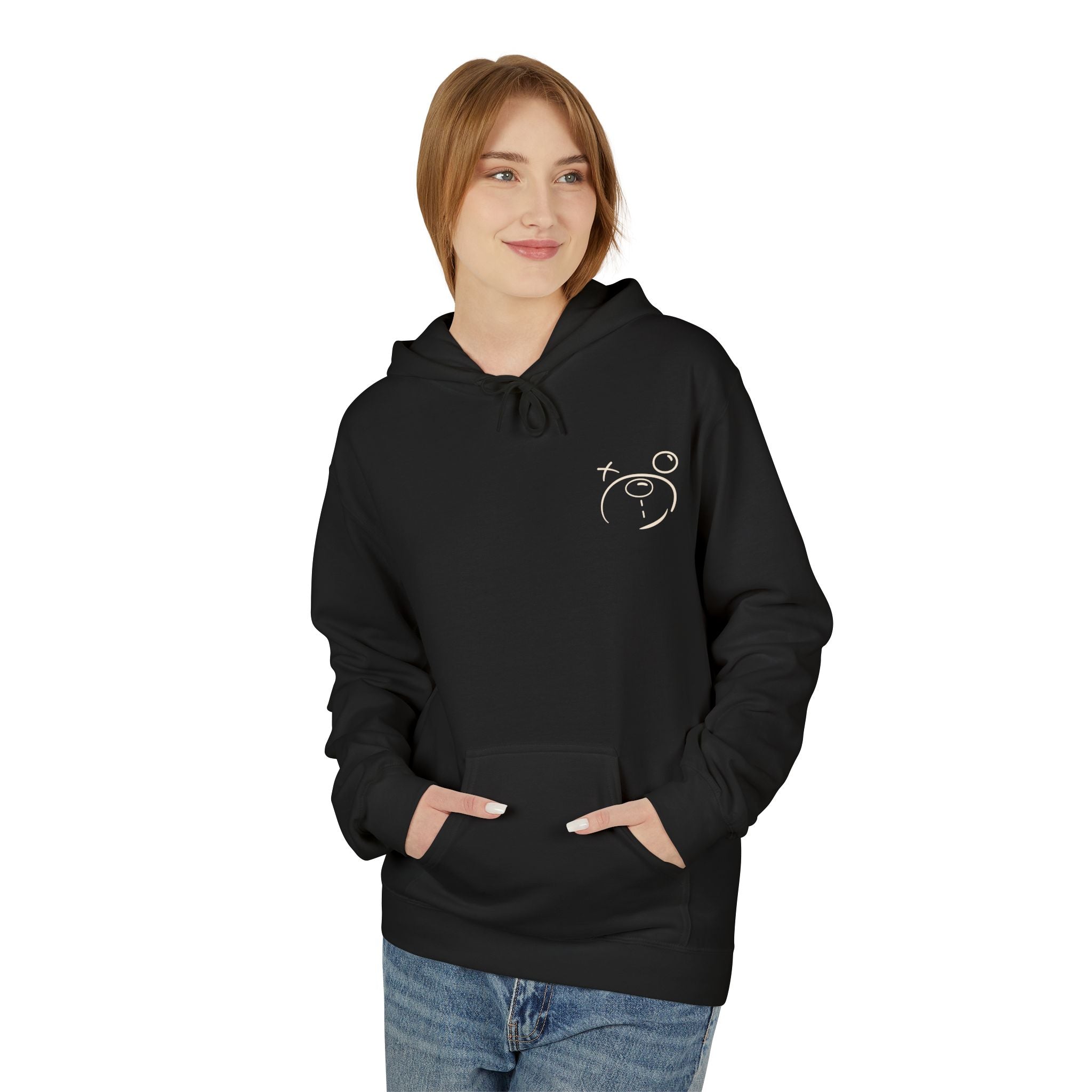 A person wearing a black "Have Fun Be 'Safe' Hoodie v3" by Printify, crafted through eco-friendly methods with a minimalist celestial front design, pairs it with blue jeans against a plain backdrop.