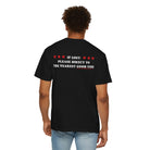 A person is wearing The Good Time Tee from Printify, a premium black T-shirt made from 100% US cotton, featuring the text "If lost, please direct to the nearest good time," adorned with red stars.