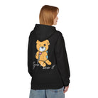 A person dons a black Grin & Bear It Hoodie from Printify, featuring a cartoon bear and text on the back, made through eco-friendly production.