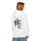 A person with shoulder-length hair is wearing the Printify Make A Mess Hoodie in a classic fit, featuring black text "MAKE A MESS OF IT ALL" on the back, paired with blue jeans.