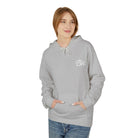 A person wears The Script Hoodie by Printify, an eco-friendly gray top with "Bn" initials. Its cozy pockets pair well with blue jeans, reflecting sustainable manufacturing.