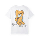 The "Grin & Bear It Tee" by Printify features a cartoon bear with a crutch and bandage, made from soft US cotton by Comfort Colors.