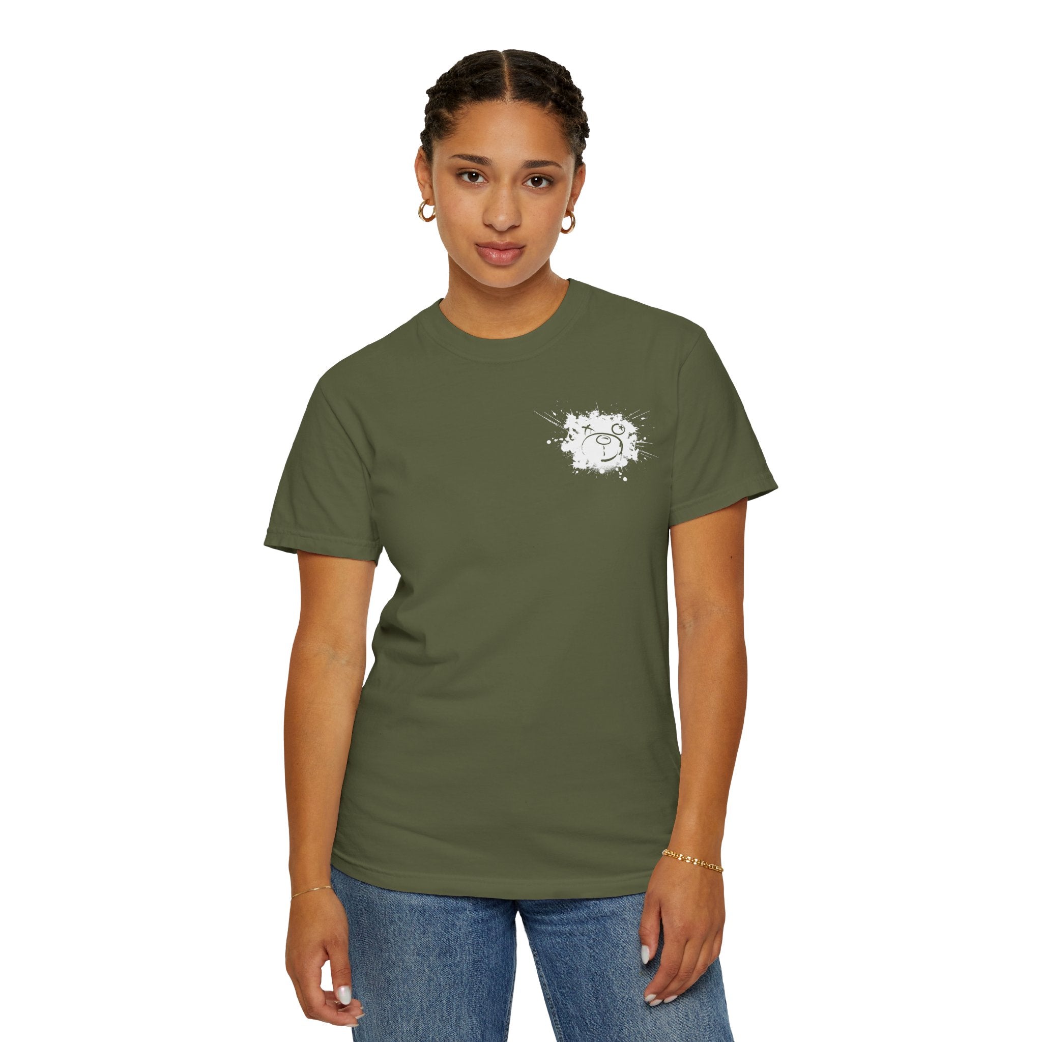 A person stands against a white background wearing Printify's Graffiti Bear Tee, an olive green Comfort Colors shirt made from 100% US cotton, featuring a small abstract design on the chest.