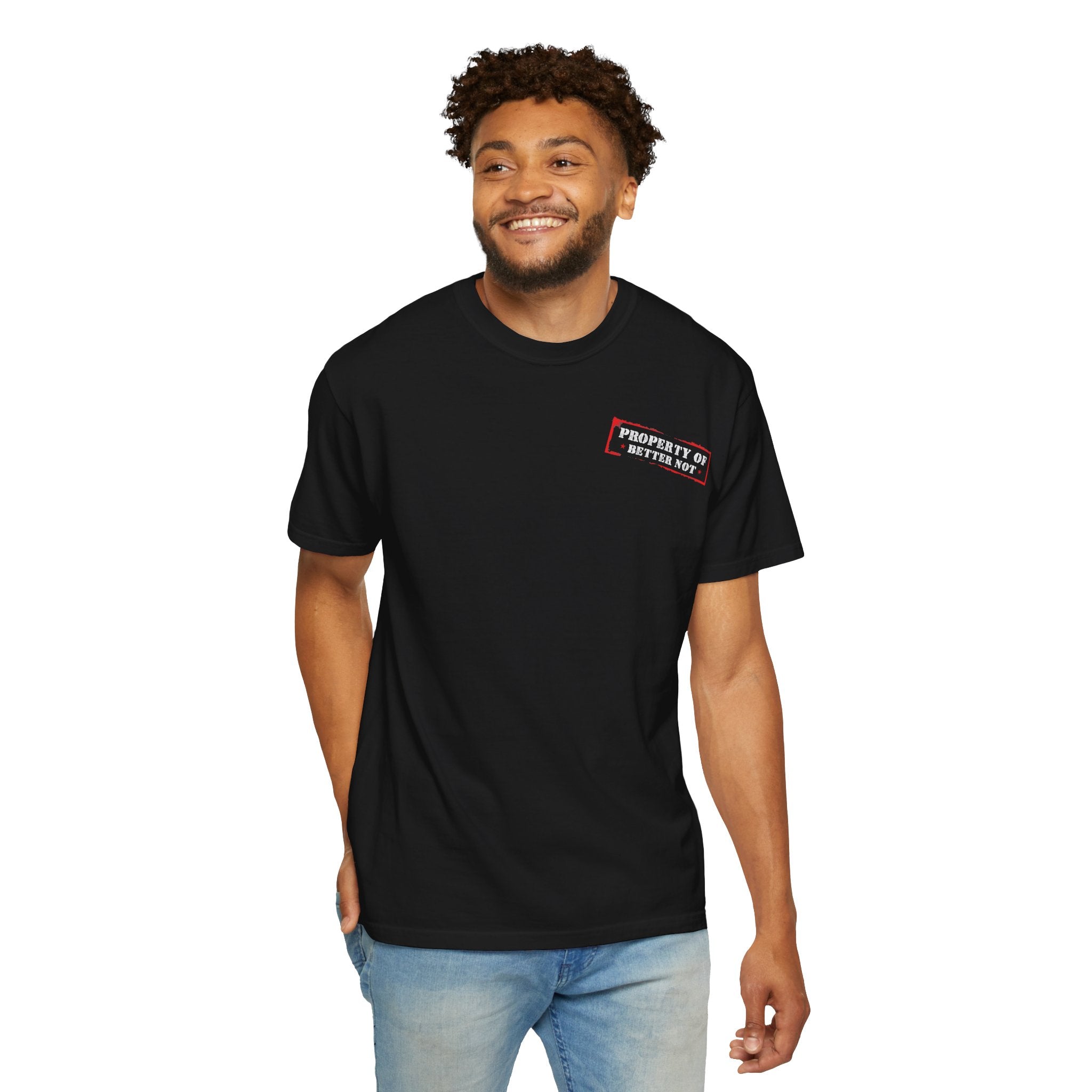 The man wears "The Good Time Tee" by Printify, showcasing black fabric with bold red and white text. Paired with blue jeans, he smiles against a white background.