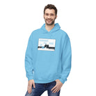 A smiling man wears a Printify Live Young Hoodie, an eco-friendly light blue top with an illustrated "Youngest I'll Be Ever" design.