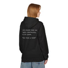 A person in a classic fit, black "What a Ride" hoodie by Printify with the text: "Life should have one loudly proclaiming at the grave, 'Wow! What a Ride!'" They are turned to the side with short brown hair and blue jeans. The hoodie is sustainably crafted using eco-friendly methods.