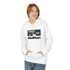 A person is wearing the "Live Young Hoodie" by Printify, featuring the text "Youngest I'll Ever Be" and a graphic on the front, made through ethical manufacturing, and standing against a plain background.