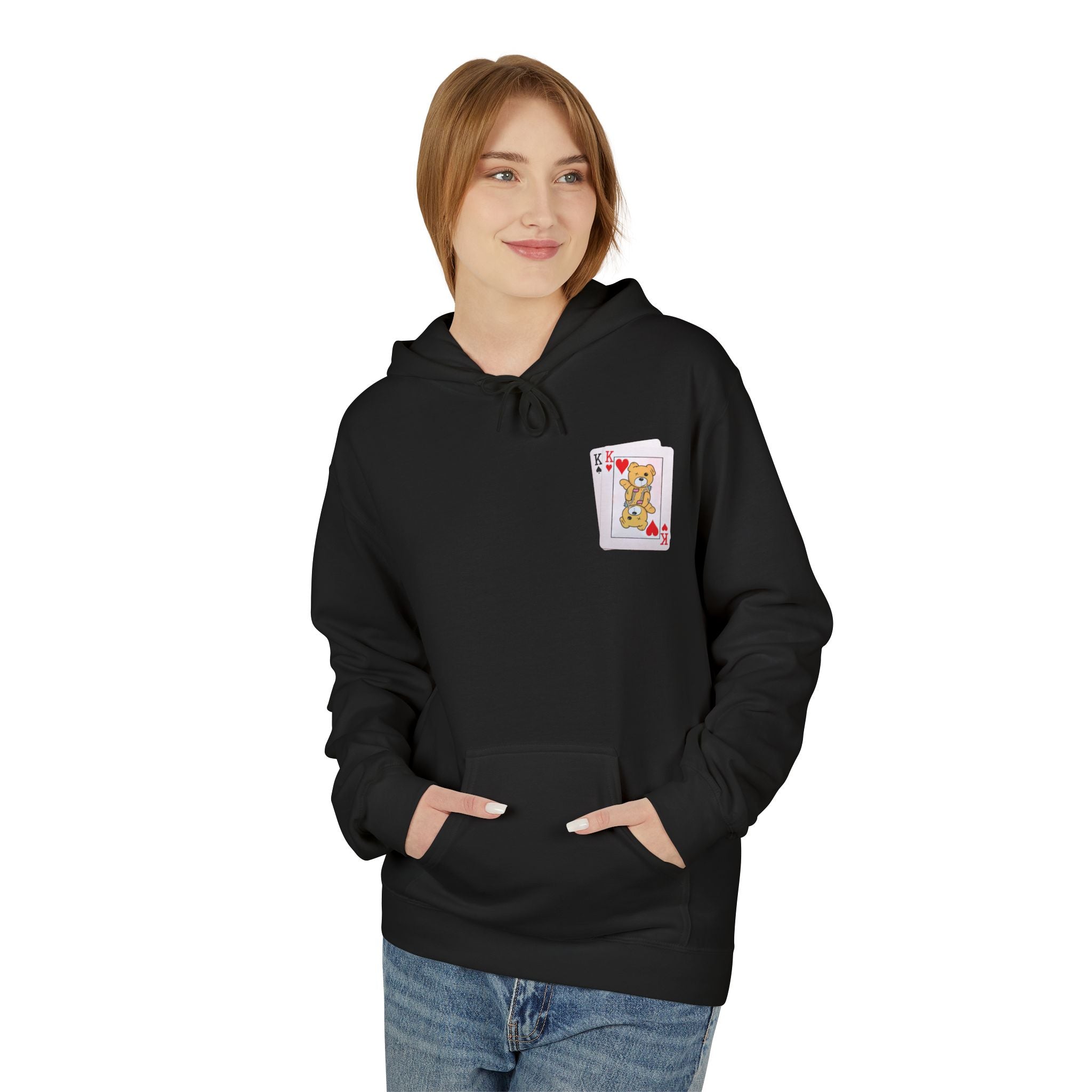 A person wears a black "Bet on Better not Hoodie" by Printify, featuring an Ace of Hearts card design on the chest, hands in the front pocket, paired with blue jeans.