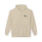 The Script Hoodie by Printify is a beige hoodie with a front pocket, drawstring hood, and small black "Bn." logo on the chest, made from eco-friendly materials through ethical manufacturing.