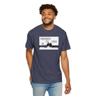 A person is wearing a navy blue Printify Live Young Tee featuring the phrase "YOUNGEST I'LL EVER BE" with a silhouette graphic. Made from 100% US cotton, this premium T-shirt provides unmatched comfort and timeless style.