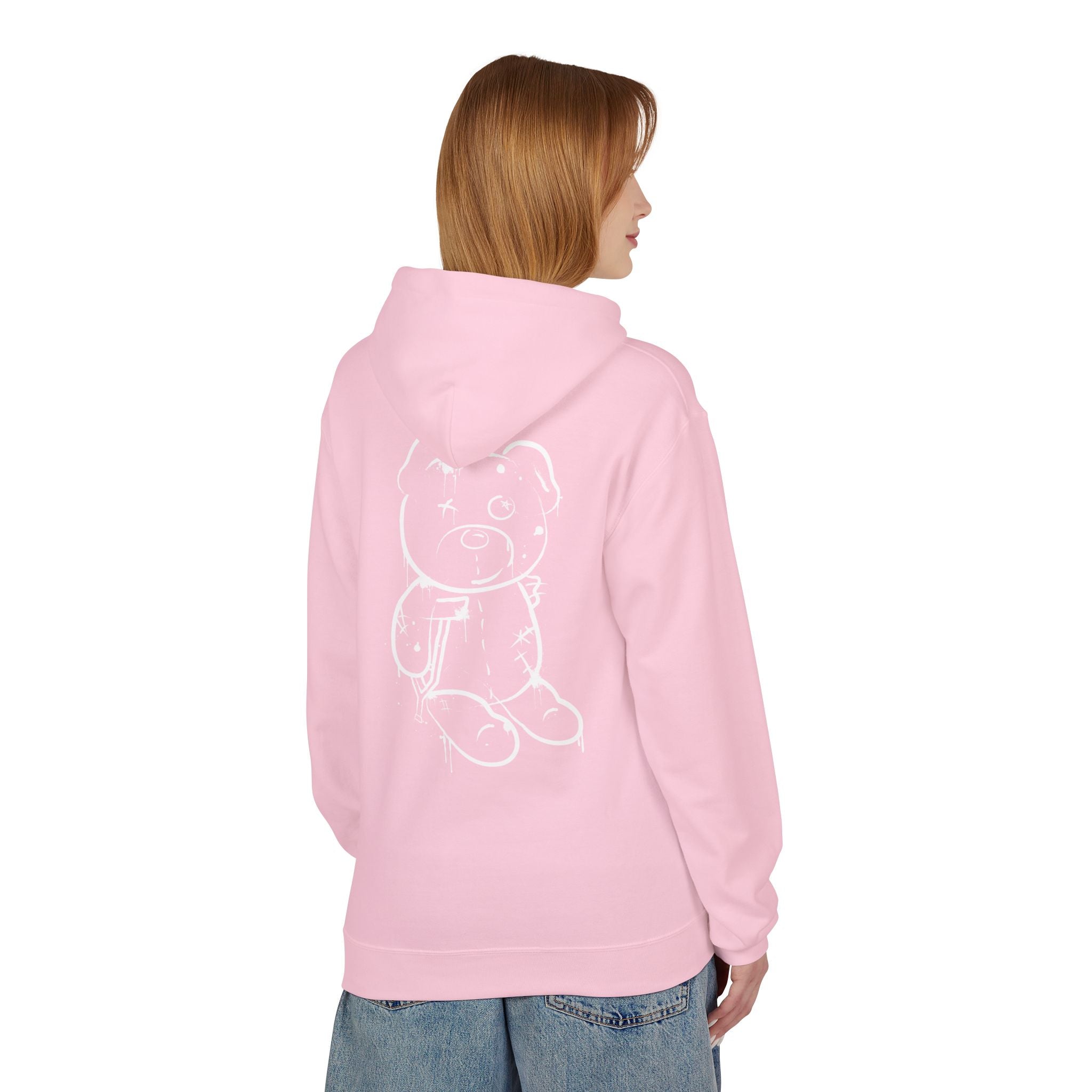 Wearing a Printify Graffiti Bear Hoodie in pink, adorned with a teddy bear graphic on the back, a person pairs it with blue jeans, standing back to the camera. This fashion choice highlights eco-friendly production.