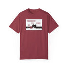 The Live Young Tee by Printify is a burgundy Comfort Colors T-shirt made from 100% US cotton. It features "Youngest I'll Ever Be" and a silhouette of a person reclining on grass, combining comfort and style in this premium tee.