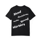 The Printify Bad Decisions Tee boasts a black design, made from 100% ring-spun cotton. It features a casual, slanted font with the phrase "Bad decisions make good stories" on garment-dyed fabric for style and exceptional softness.