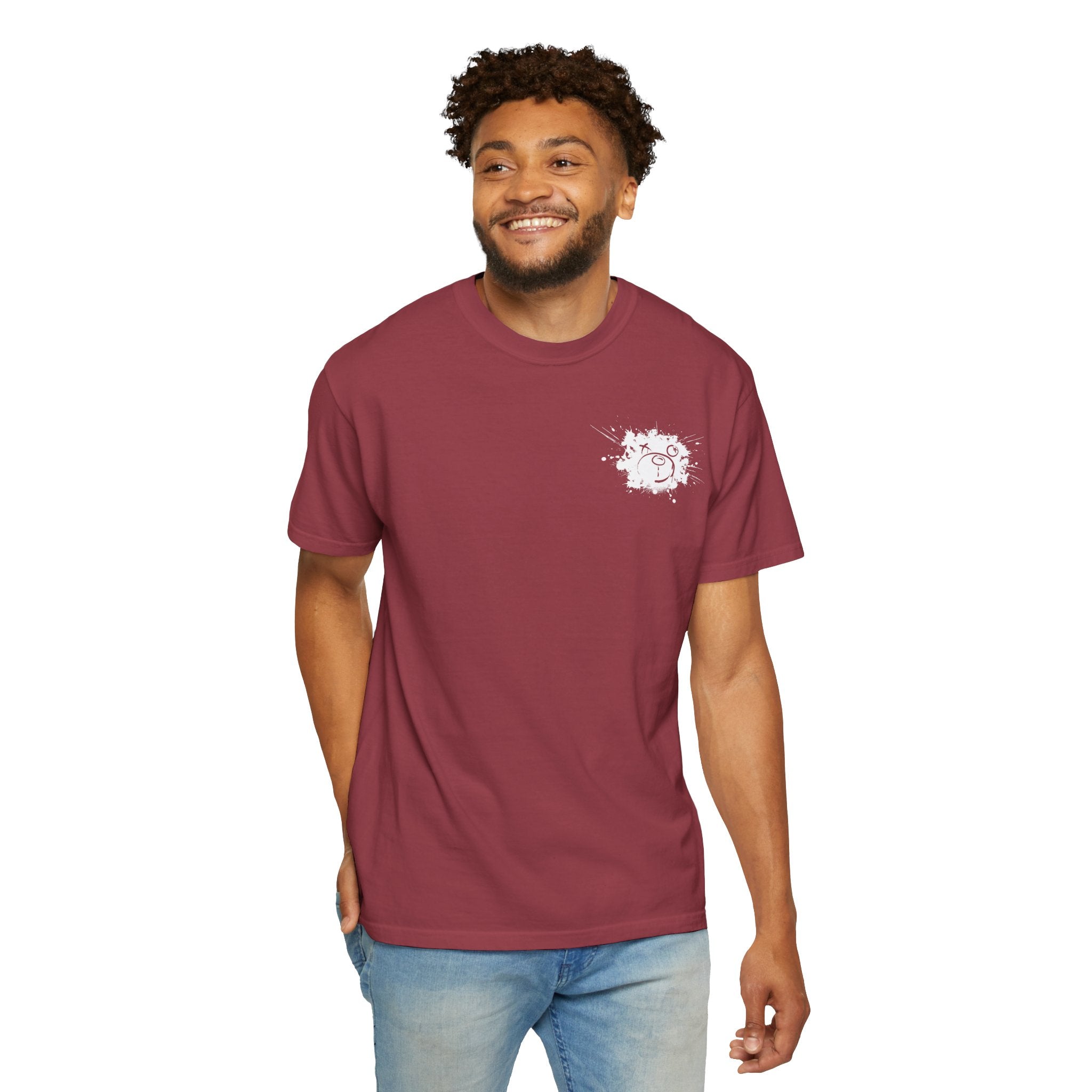 A man smiles against a plain background, wearing a maroon Graffiti Bear Tee by Printify, made from 100% US cotton and featuring a small white graphic on the chest.