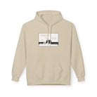 The "Live Young Hoodie" by Printify is a beige hoodie with a graphic reading "YOUNGEST I'LL EVER BE" above a silhouette and crowd, crafted from eco-friendly materials to combine style and sustainability for conscious consumers.