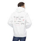 A person wears the No Map Needed Hoodie by Printify, a classic fit white hoodie featuring "We don't need a map for where we're going" in playful font on the back, made with eco-friendly production methods.