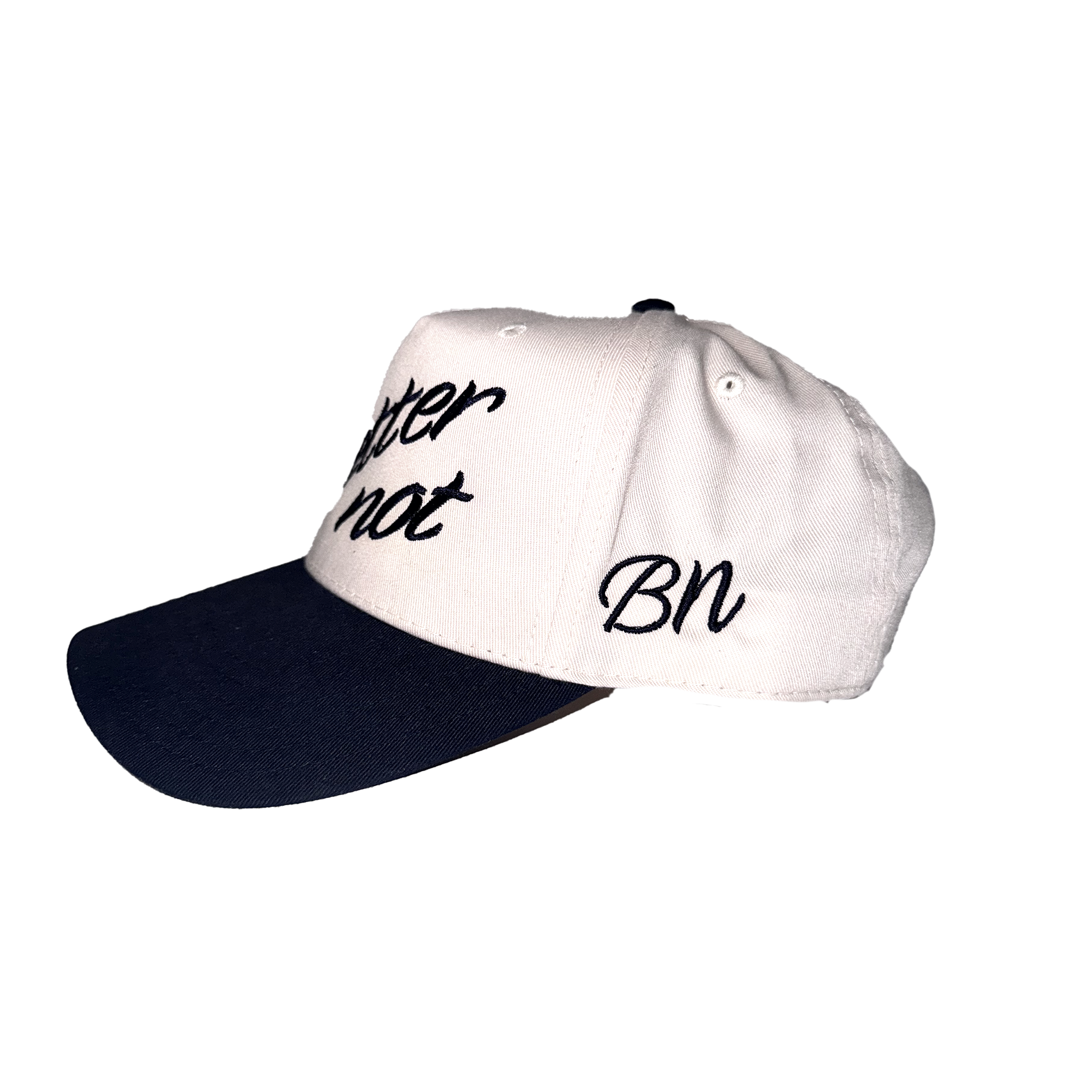 A white and navy 5-panel hat with the phrases "better not" and "bn" embroidered in black script on the front of The Classic hat by Better Not.