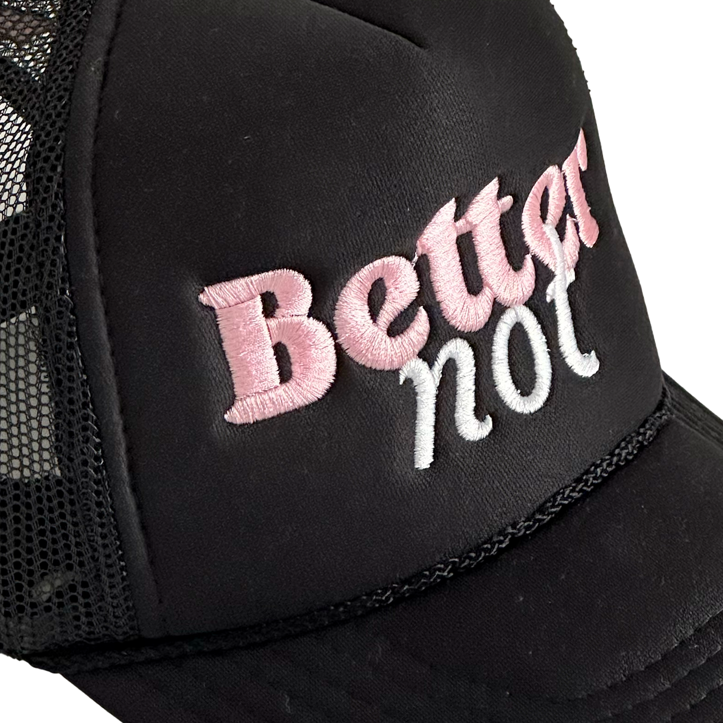 The Classic Trucker cap by Better not features a black mesh-back with "Better not" meticulously embroidered in pink and white on the front panel. This stylish accessory comes with a Mid Crown fit and next day shipping available.